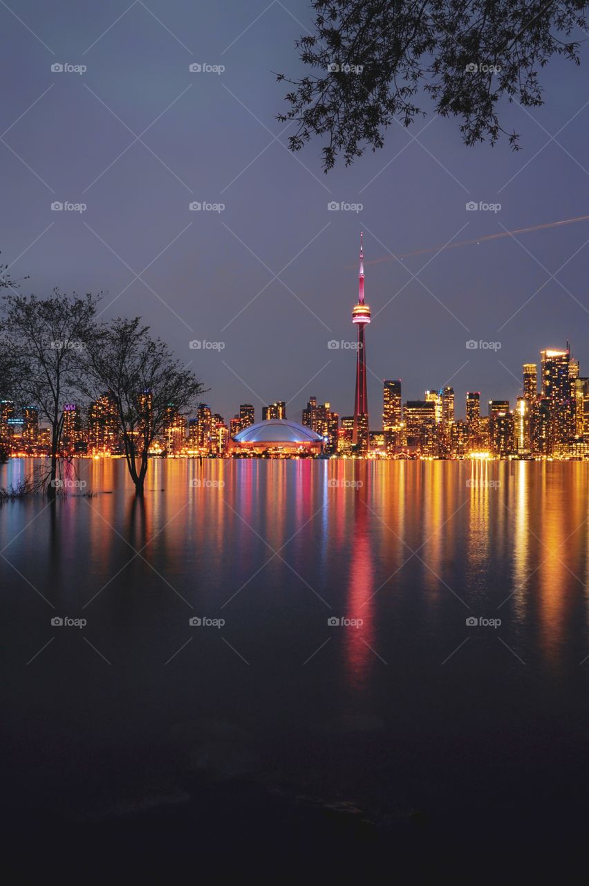 Toronto's skyline at dusk perfectly reflected in the water