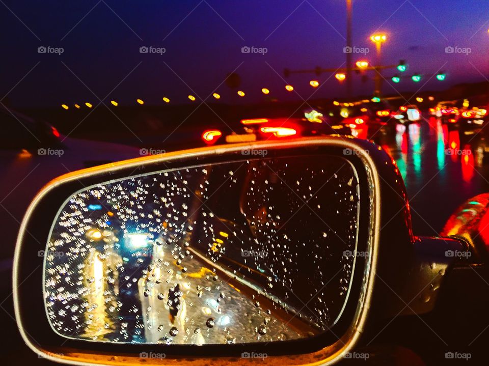 Rain droplets on a side car window 