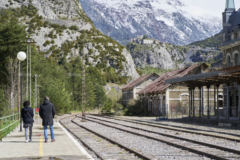 Rear view of people walking at railway station