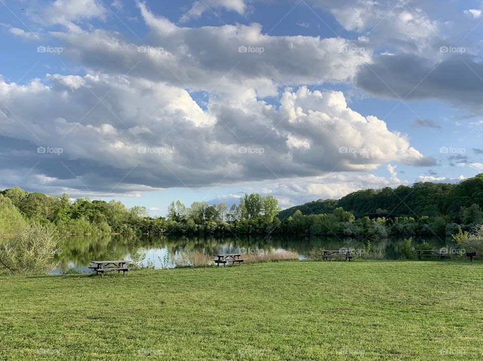 Blue skies with puffy clouds over lake