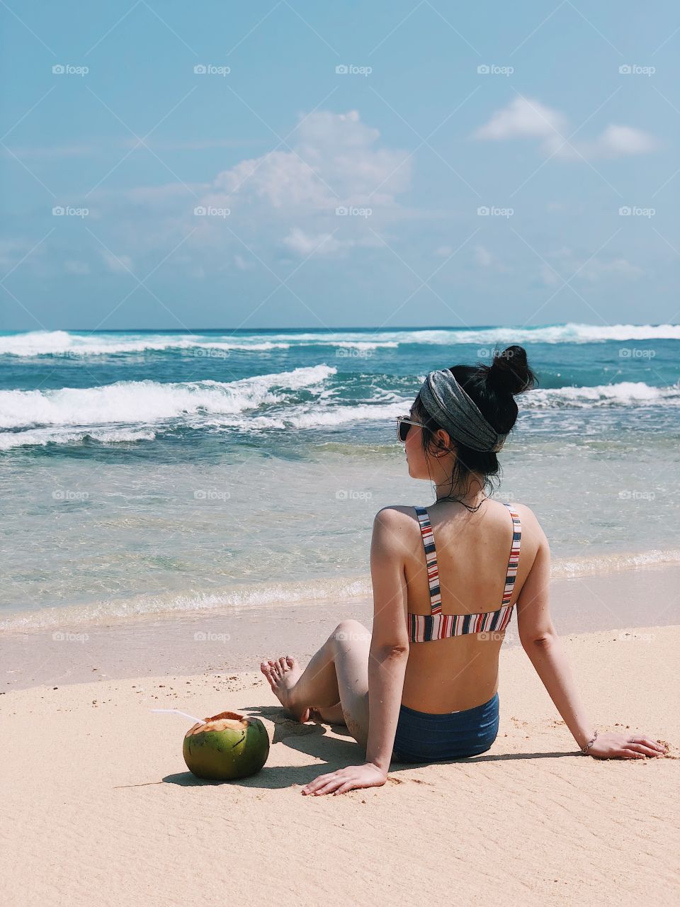Chilling by the beach with stylish swimsuit and a coconut