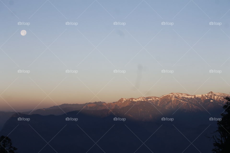 sun rays and moon watching mountain