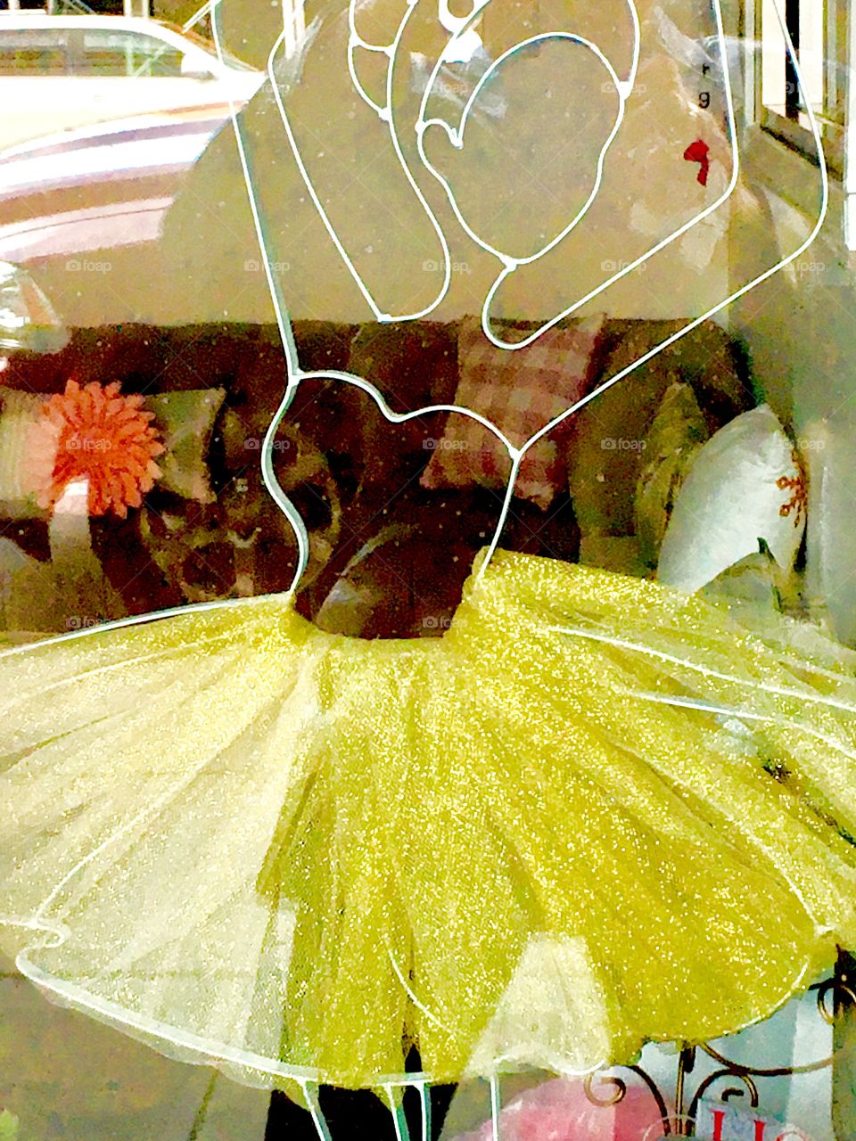 A display window advertising for a dance school „Fall in Love with Dance“ in Long Island City, Queens with window decoration and yellow tutu, reflections in the glass and parts of the interior. 2018. Hypnotic Productions