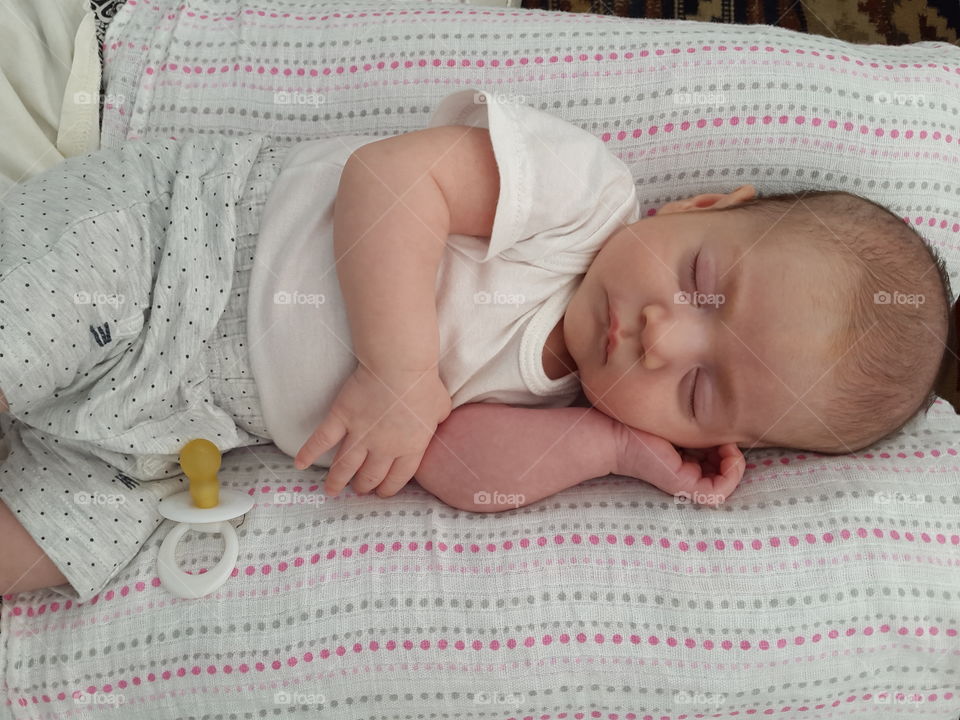 Caucasian baby sleeping on bed