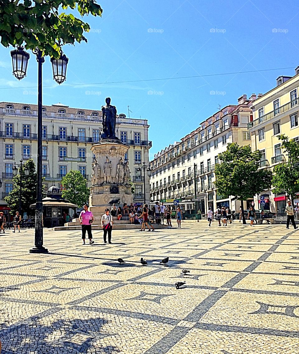 Tourists near statue in the city