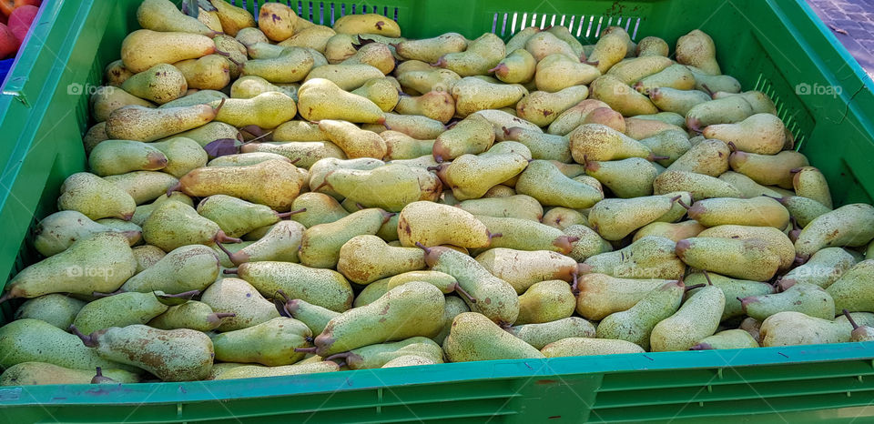 Freshly-picked juicy pears for sale at the farmers' market in Spello, Italy.