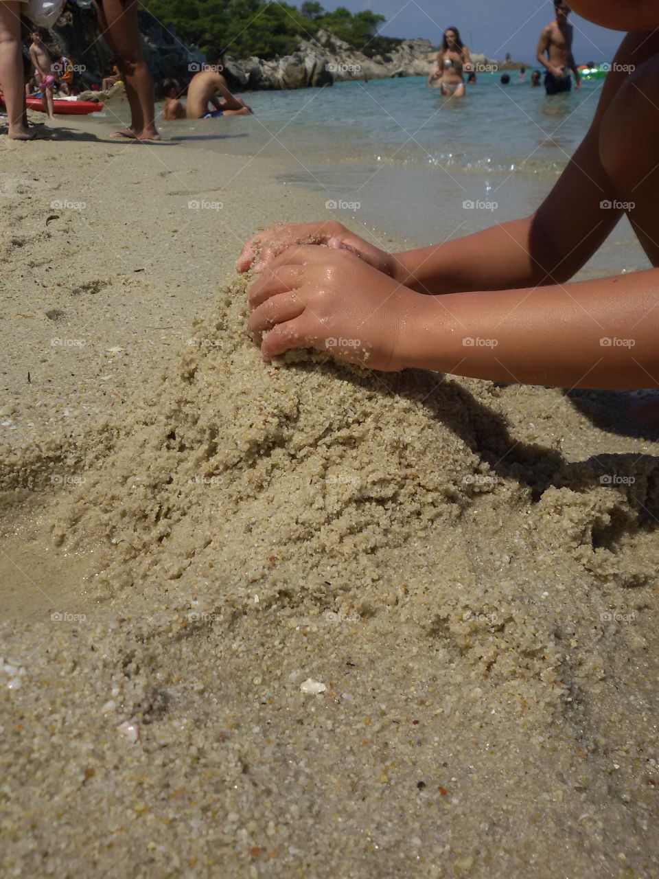 Boy's hands in the sand