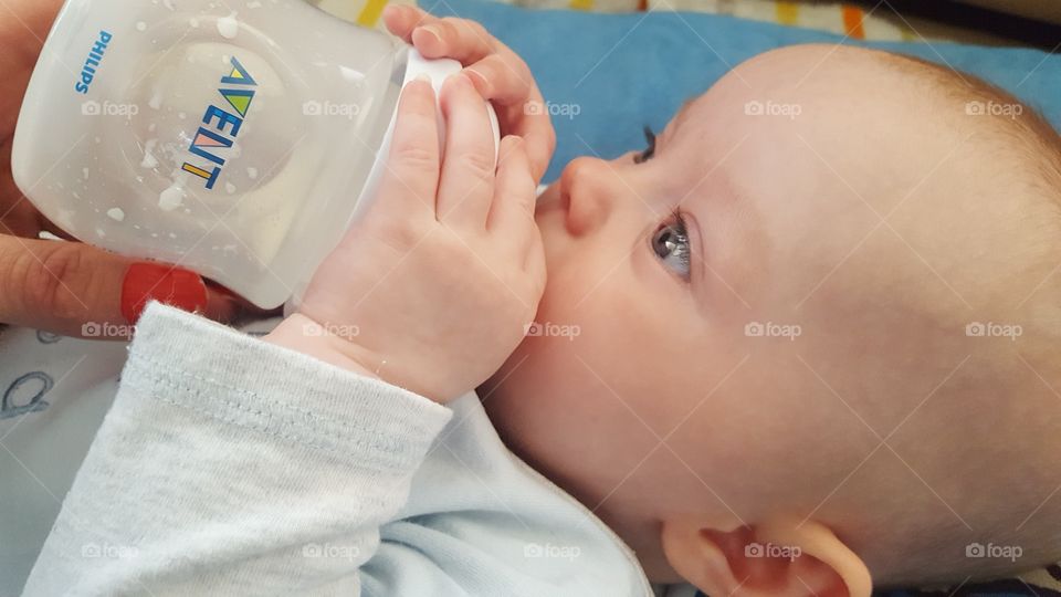 Baby drinking milk from bottle