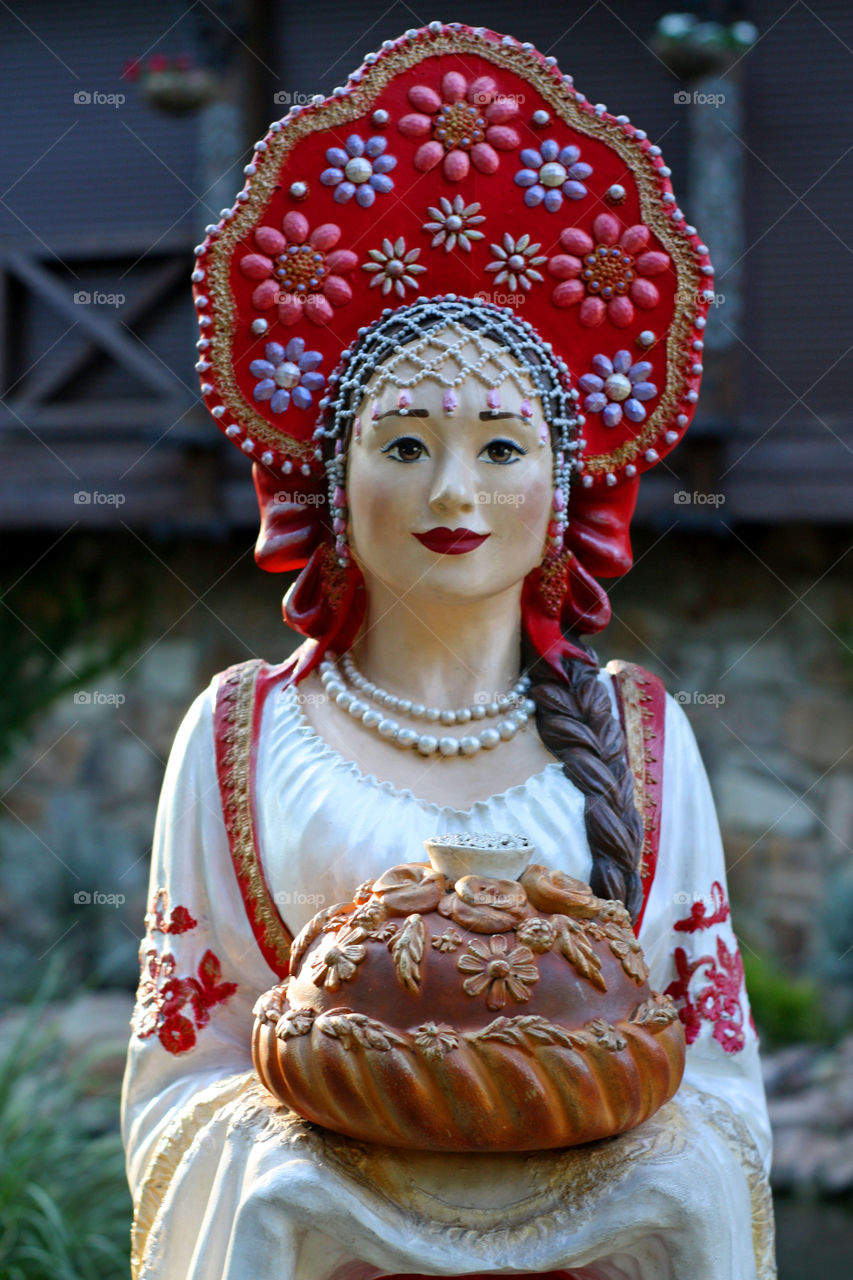 girl in national clothes offers bread with salt