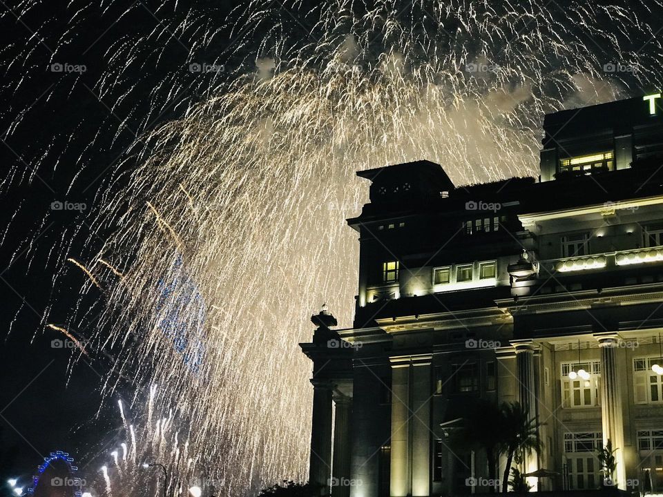 Welcoming new year with bright fireworks near Fullerton hotel at Singapore 