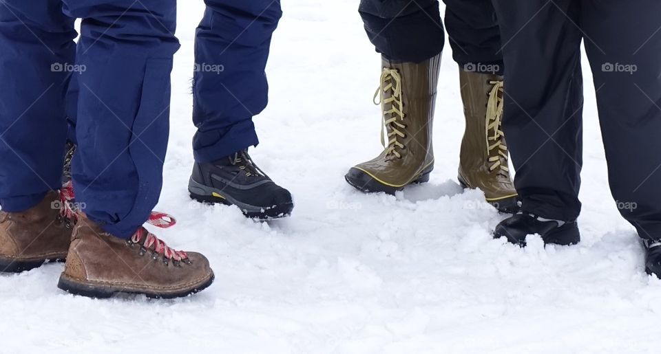 A group of people stand together preparing to enjoy winter fun together. 