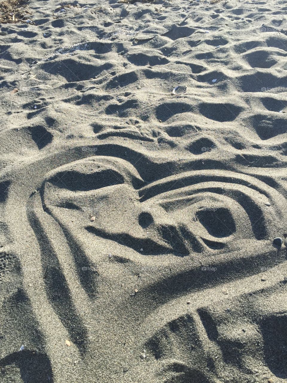 Sand Face. Heart Face in the Sand