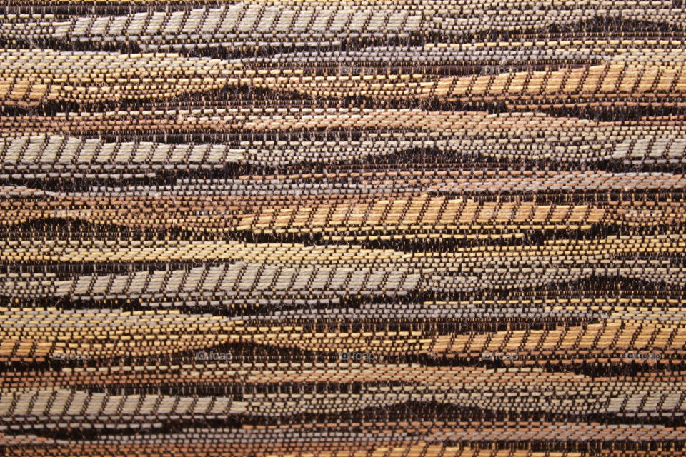 Multi-patterned brown pillow close-up