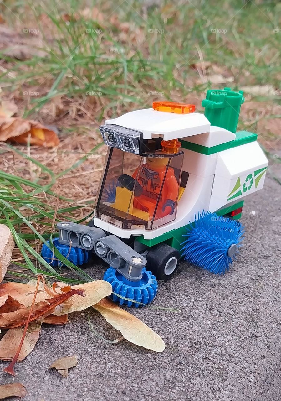 cleaning streets in autumn: little cleaning car