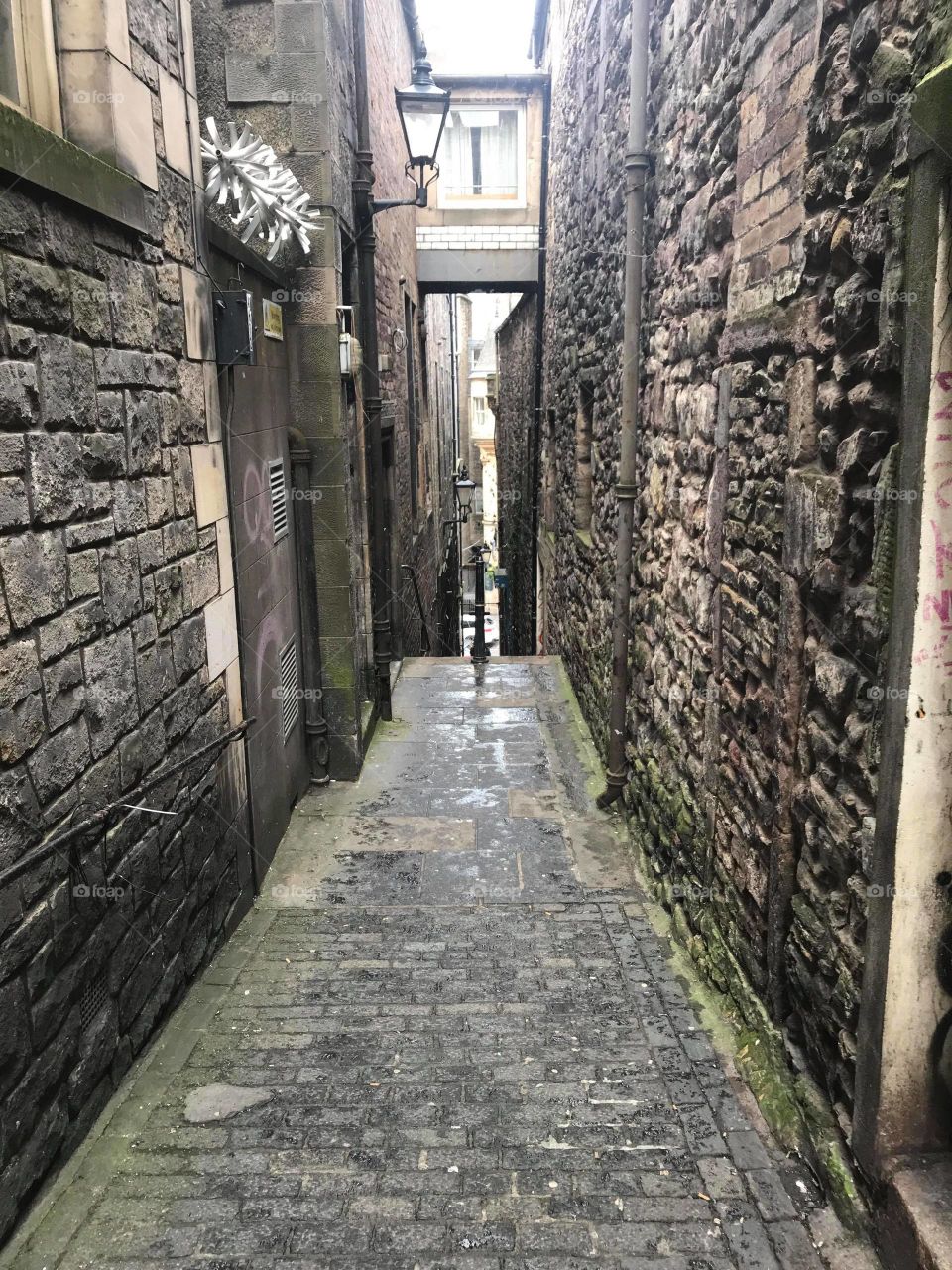 narrow dark empty ancient stone alleyway