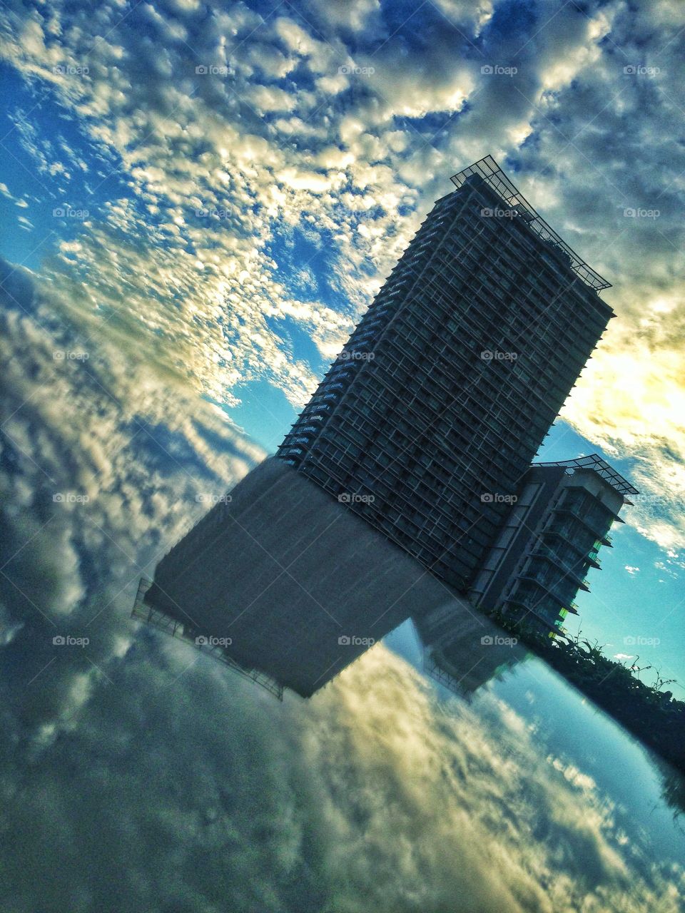 Skyscraper reflection on a sunny day with clouds