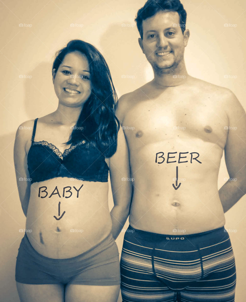Me and the hubby enjoying our pregnancy, each in his own way lol