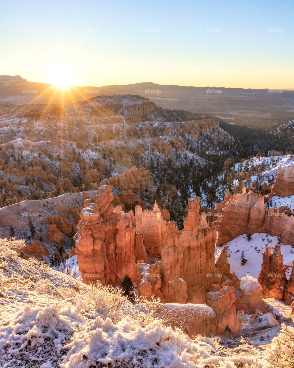 Sunrise over a snow covered winter scene in Bryce Canyon National Park.