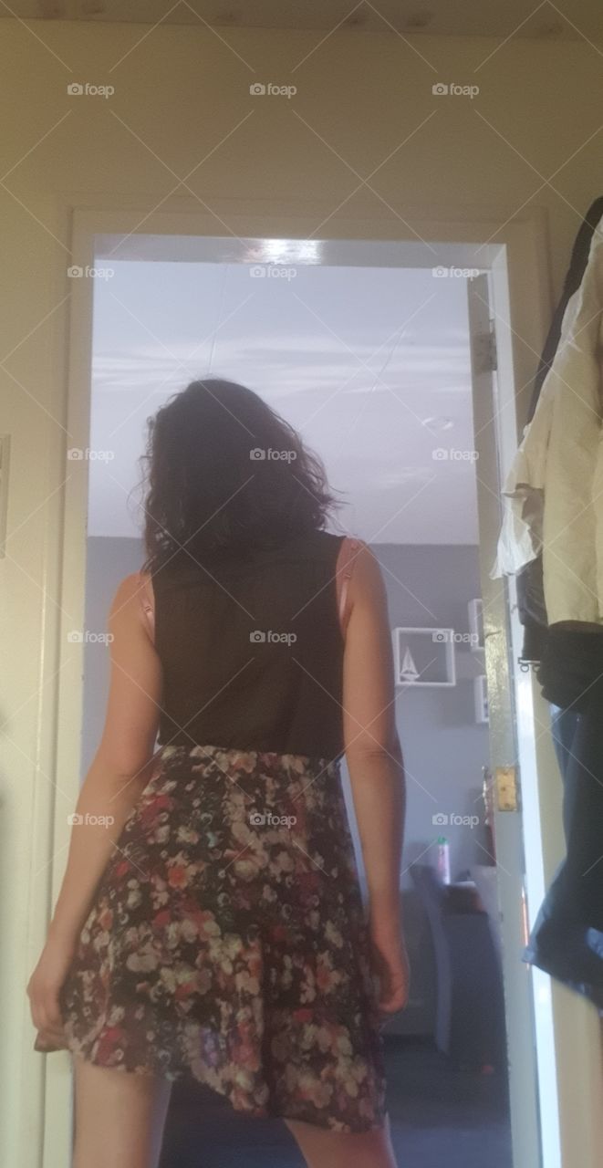 Stand in the doorway. Taking a position in front of the camera