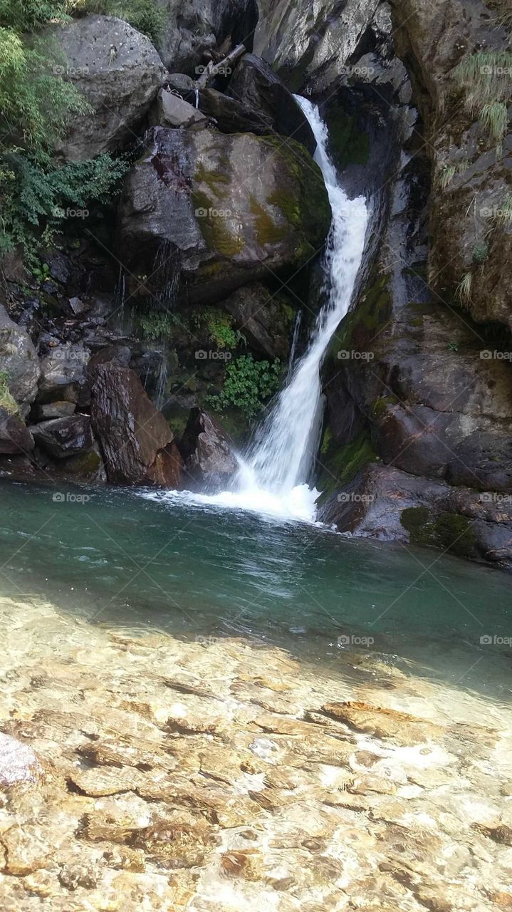 Waterfall falling from the mountain Everyone who sees them can be happy. This is an amazing beauty of a nature. Beautiful naturalness