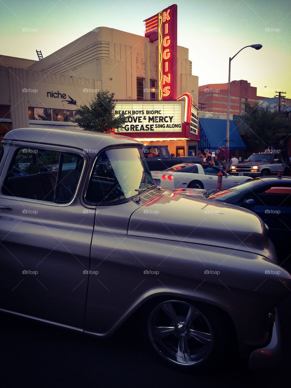 Classic pickup in downtown. Vintage pickup parked in front of vintage movie theater