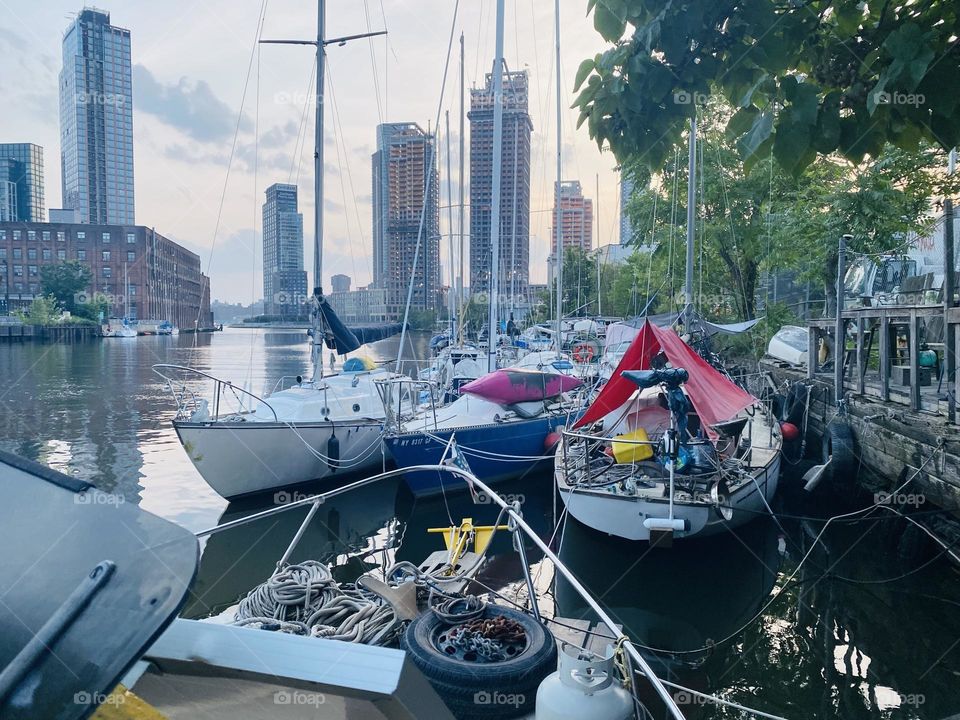 The various different kinds of boats of “Newtown Creek” in LIC, Queens stretch out before you into the distance. This particular view can only be enjoyed if you are standing aboard one of them. 2023. Hypnotic Productions