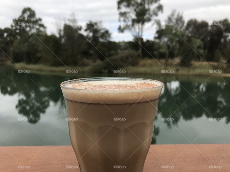 Latte sipping over a peaceful lake