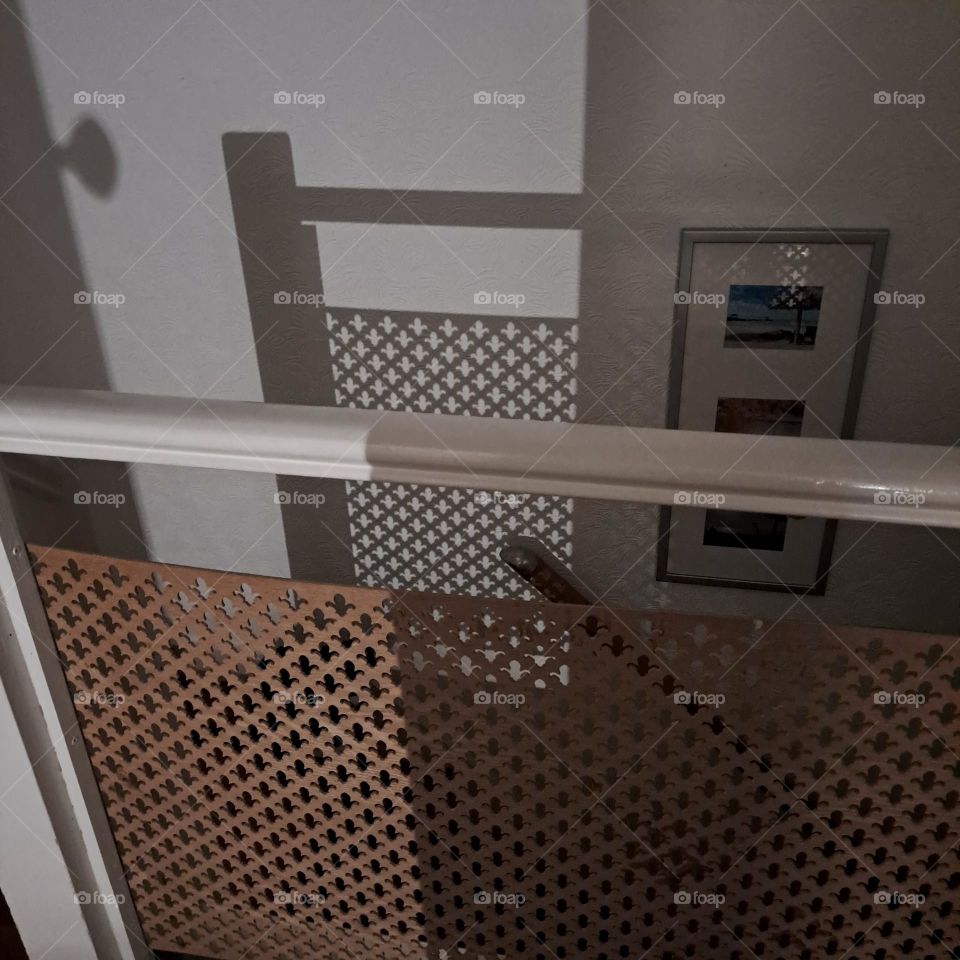 evening shadows created by artificial light indoors. landing, top of stairs
