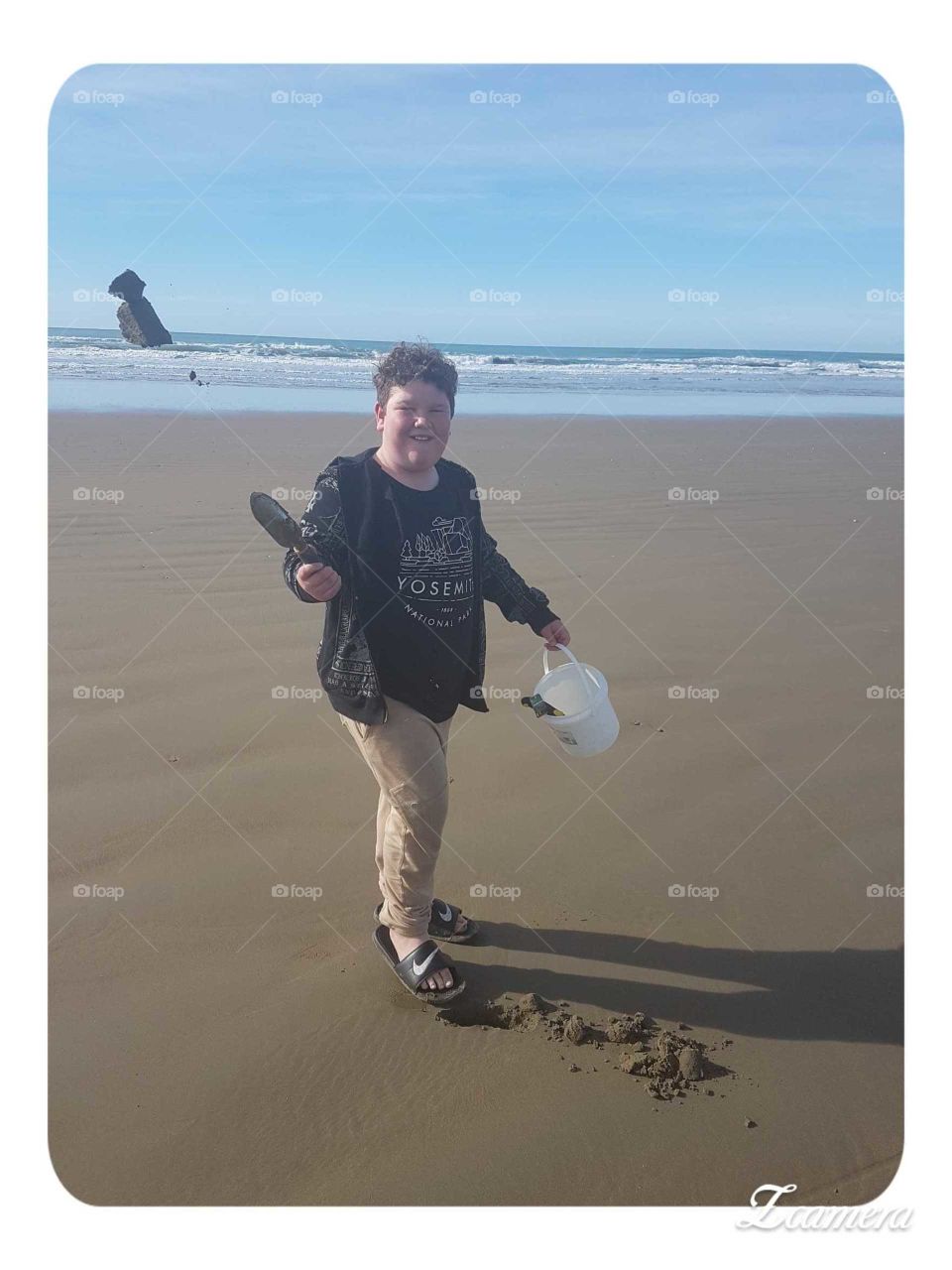 A fun day out on Parangahau beach NZ. My son flips sand into the air with his little sand shovel. I capture the moment.