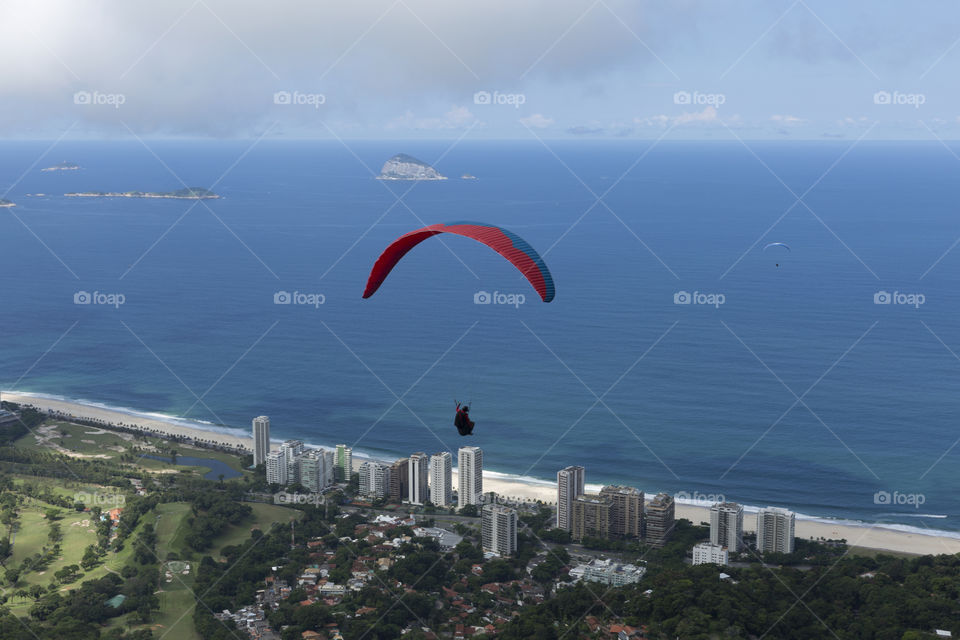 Paraglider flying over Sao Conrrado in Rio de Janeiro Brazil.