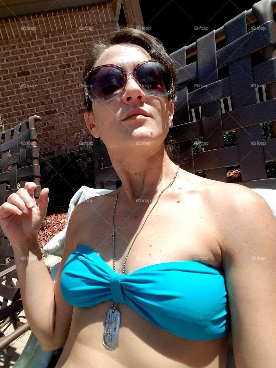 Young woman in bikini top sunglasses