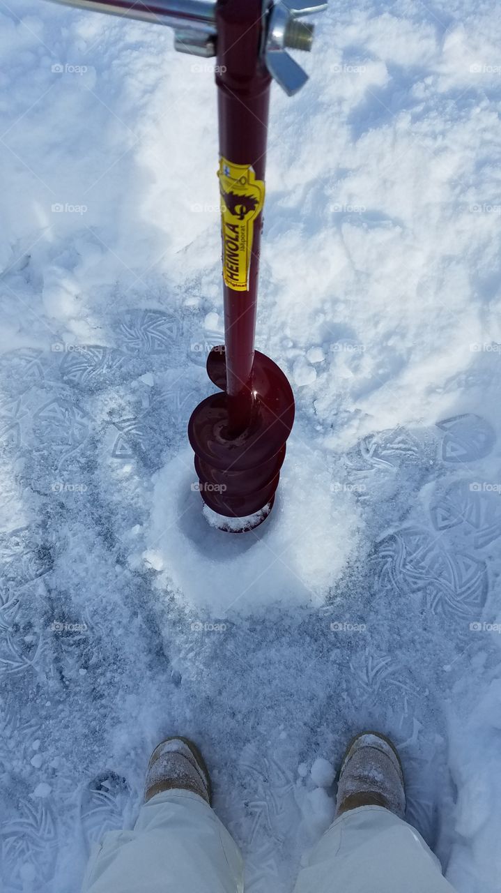 Drilling ice fishing hole