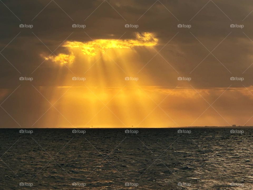 Spectacular Crepuscular rays over the water - Shafts of light which are seen just after the sun has set and which extend over the western sky radiating from the position of the sun below the horizon