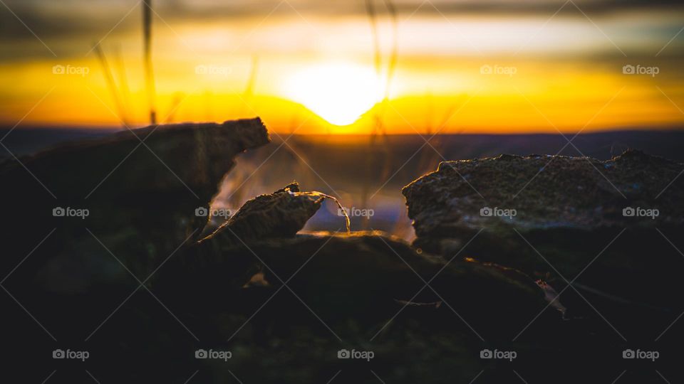 Rocky structure perfectly frames sunset.