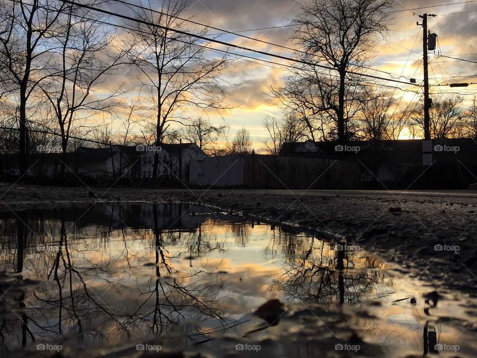 Sunset reflected in puddle