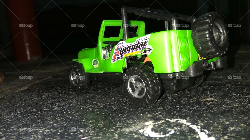 children paying jeep toy