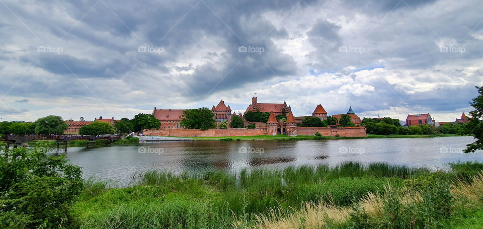 The view of historical castle of the Teutonic Order in Malbork seeing from the other side of river Nogat