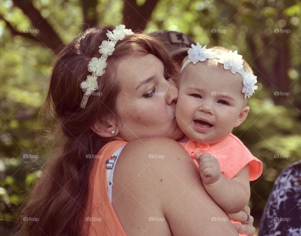 Mother kissing her baby girl