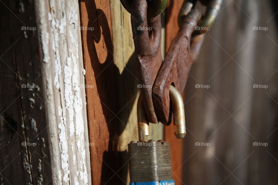 Multicolored wooden fence 
Chain and padlock