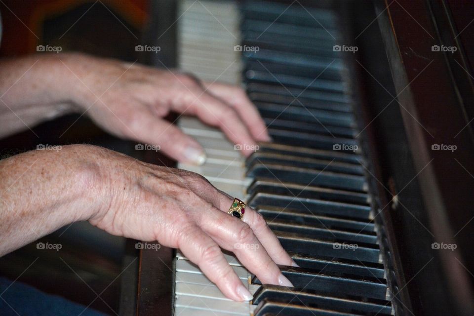 Old hands playing piano