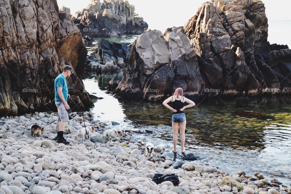 People on a stone beach