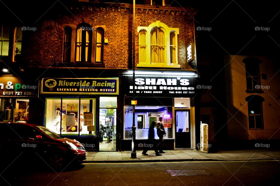 2 guys walk down the pub filled street of Liverpool looking for a warm place to stop for their next pint. 