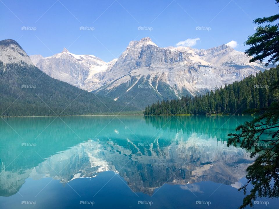 Snowy mountain reflected on lake