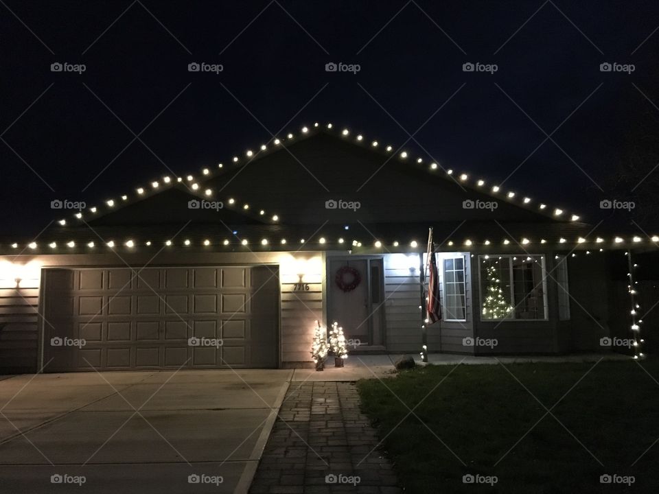 Small house celebrating Christmas time with beautiful lights. 