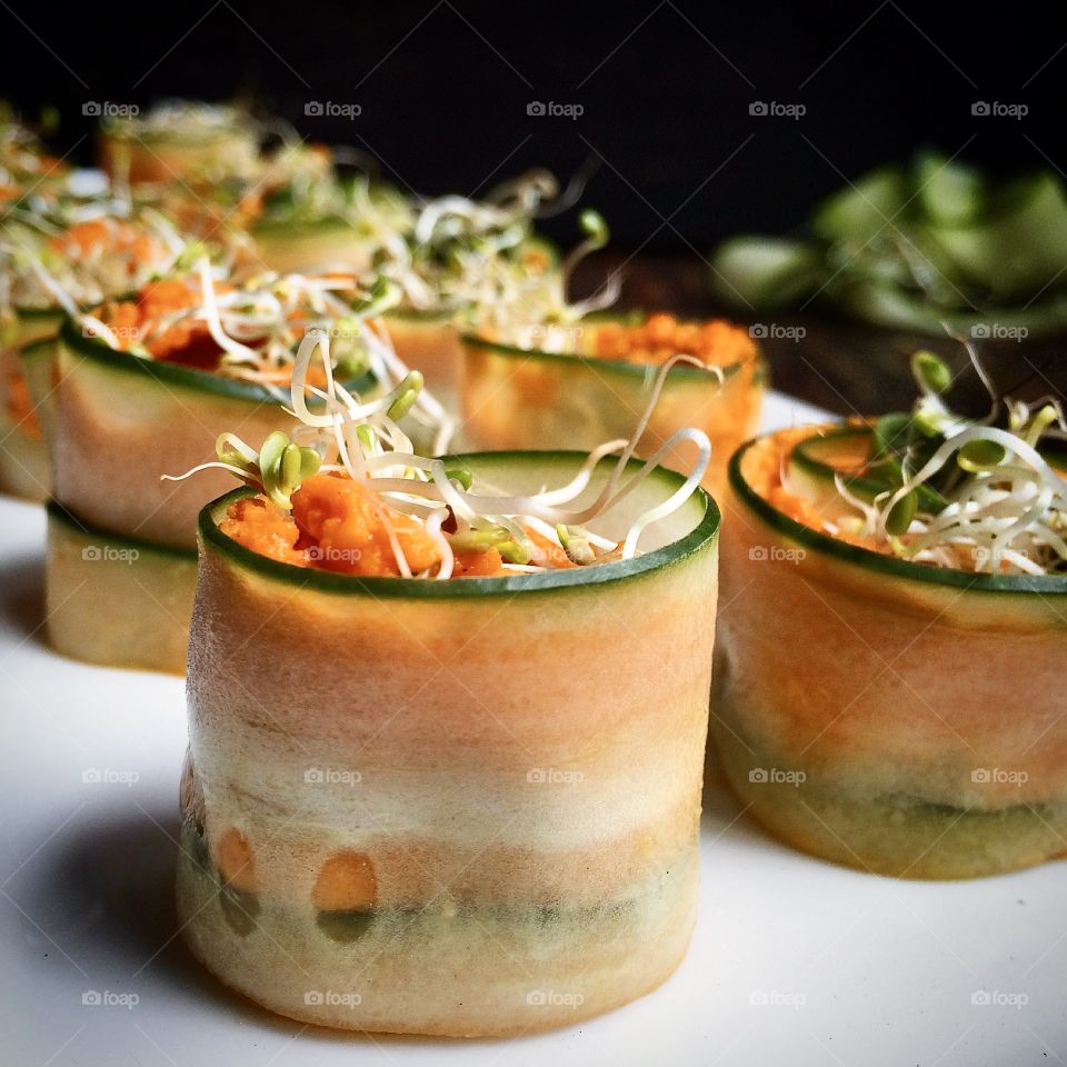 Fresh Cucumber Rolls with red pepper hummus and sprouts