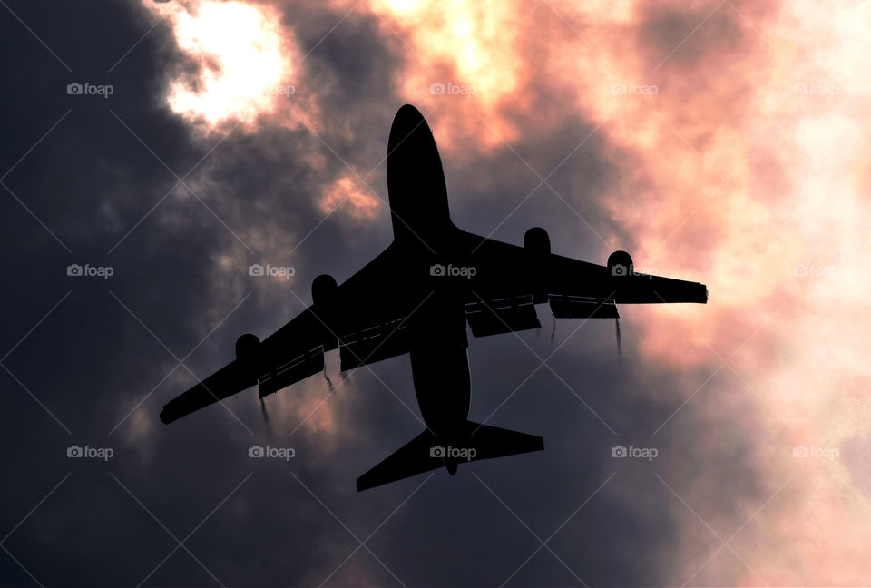 Silhouette Beauty. A Boeing 747-400 emerges from the clouds on finals to Islamabad international Airport.