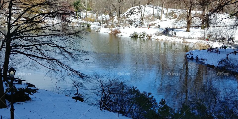 The lake in Central Park after the 4th nor' easter storm in New York City in March of 2018. Snow in springtime.