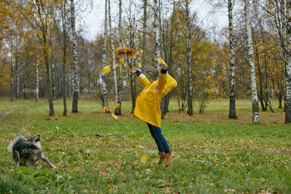 boy jumping with leaves