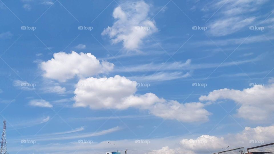 beautiful clouds that look like they were painted with a brush in the blue sky