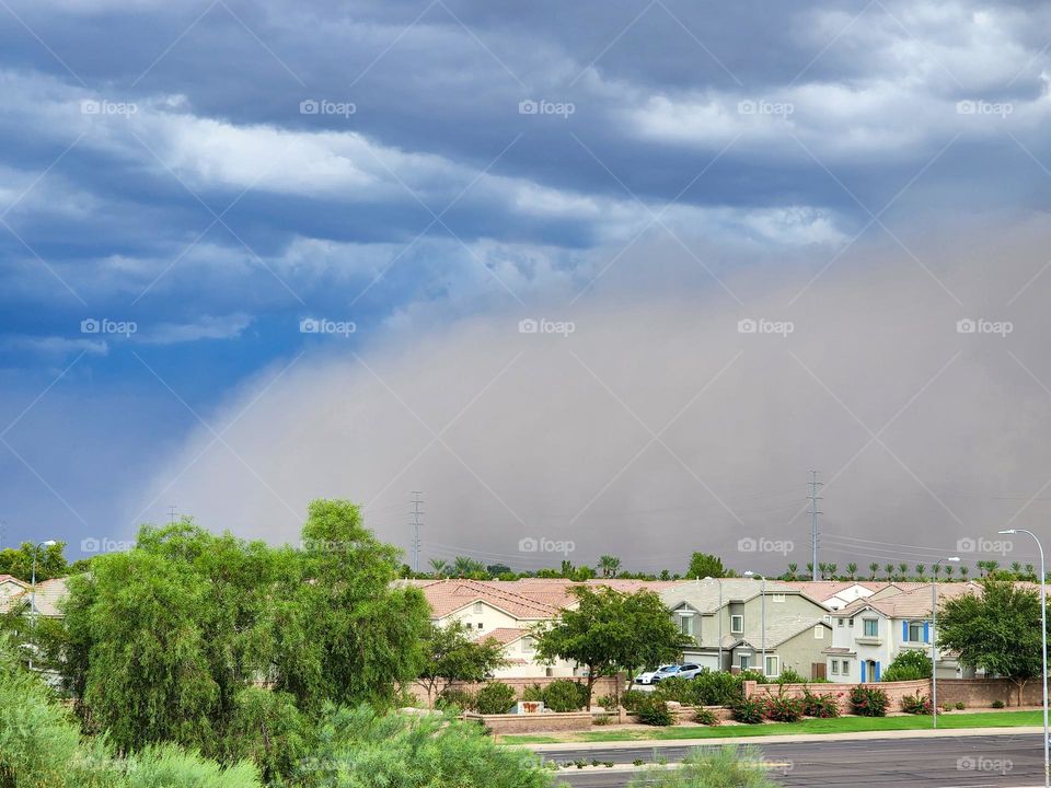 A dust storm moves into the Phoenix area preceding a thunderstorm. Outbound winds from the thunderhead kick up loose desert sand.